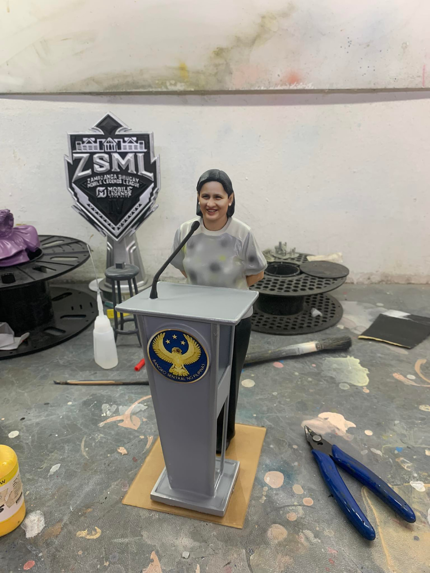 Full-color 3D printed figurine of a woman speaking at a miniature podium